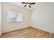 Bright bedroom with light wood floors and ceiling fan at 10282 Country Flats Ln, Las Vegas, NV 89135