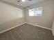 Bright bedroom with gray carpeting and a ceiling fan at 3136 Van Der Meer St, North Las Vegas, NV 89030