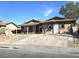 Tan house exterior with a paved driveway and landscaping at 3136 Van Der Meer St, North Las Vegas, NV 89030