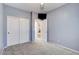 Light gray walls and carpeted floors in this well-lit bedroom with double doors leading to a closet and additional doors to other rooms at 3760 Lodina Ct, Las Vegas, NV 89141