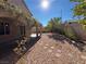 Landscaped backyard with covered patio and stone pathway at 5945 Moon Garden St, Las Vegas, NV 89148