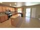 Kitchen with wood cabinets, granite counters, and stainless steel appliances at 5945 Moon Garden St, Las Vegas, NV 89148