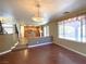 Open living room with hardwood floors and a view of kitchen and staircase at 5945 Moon Garden St, Las Vegas, NV 89148