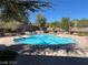 Community pool with lounge chairs and umbrellas at 5945 Moon Garden St, Las Vegas, NV 89148