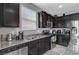 Kitchen features dark cabinetry, granite counters, and stainless steel appliances at 7485 Earnshaw Ave, Las Vegas, NV 89179