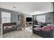 Spacious living room with gray sectional sofa, large TV, and Christmas tree at 7485 Earnshaw Ave, Las Vegas, NV 89179