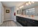 Double vanity bathroom with large mirror and shower at 10529 Parthenon St, Las Vegas, NV 89183