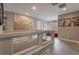 Upstairs hallway with glass railings, light gray walls, and wood-look flooring at 10529 Parthenon St, Las Vegas, NV 89183