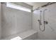 Walk-in shower with marble walls and built-in seat at 10669 Aphrodite St, Las Vegas, NV 89183