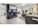 Living room featuring gray sectional sofa, fireplace, and large TV at 2029 Valley Dr, Las Vegas, NV 89108