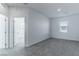 Spacious bedroom with gray carpet and access to another room at 230 Palisade Falls Ave, Henderson, NV 89015