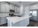 Spacious kitchen with gray cabinets, white countertops, and stainless steel appliances at 230 Palisade Falls Ave, Henderson, NV 89015