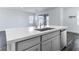 Kitchen island with white countertop, stainless steel sink, and gray cabinets at 230 Palisade Falls Ave, Henderson, NV 89015