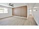 Bright bedroom with gray carpeting and a wood accent wall at 3101 Kings Way, Las Vegas, NV 89102