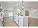 Open concept kitchen with white cabinets, island, and view into adjacent living area at 3101 Kings Way, Las Vegas, NV 89102