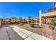 Landscaped backyard with covered patio and walkway at 3105 Madame Plantier Ave, North Las Vegas, NV 89081