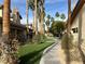 Pathway through a community with lush landscaping and palm trees at 5070 Tara Ave # 119, Las Vegas, NV 89146