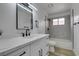 Modern bathroom with white vanity, black matte fixtures, and grey tile at 7413 Turtle Dove Ct, Las Vegas, NV 89129