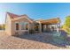 Tan stucco house with a covered patio and gravel landscaping at 8908 Marble Dr, Las Vegas, NV 89134