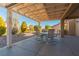 Covered patio with a table and chairs, overlooking the backyard at 8908 Marble Dr, Las Vegas, NV 89134