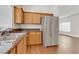 Kitchen features stainless steel refrigerator and wood cabinets at 1018 Maple Pines Ave, North Las Vegas, NV 89081