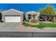 Single-story home with a two-car garage and well-manicured lawn at 10236 Rio De Thule Ln, Las Vegas, NV 89135