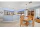 Modern kitchen with gray cabinets, island, and breakfast nook at 10236 Rio De Thule Ln, Las Vegas, NV 89135