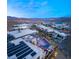 Aerial view of modern homes, lake and mountains at dusk at 12 Falling Canyon Ct, Henderson, NV 89011