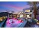 Luxury pool with a fire pit and palm trees at sunset at 12 Falling Canyon Ct, Henderson, NV 89011