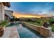 Relaxing pool and spa with a stone water feature and sunset views at 1987 Orchard Mist St, Las Vegas, NV 89135