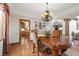 Elegant dining room features a large wood table, chandelier, and hardwood floors at 220 Hallett Cove Ct, Boulder City, NV 89005