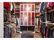 Spacious walk-in closet with custom shelving and red accented doors at 28 Tea Olive Dr, Las Vegas, NV 89141