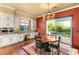 Kitchen dining area with wood table and access to backyard at 28 Tea Olive Dr, Las Vegas, NV 89141