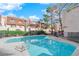 Inviting community pool with surrounding trees and patio at 3555 Arville St # 105C, Las Vegas, NV 89103