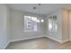 Bright dining room with light gray walls, wood-look flooring, and a chandelier at 4327 Bassae Temple Ave, North Las Vegas, NV 89031