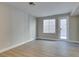 Bright living room with wood-look floors and access to backyard patio at 4327 Bassae Temple Ave, North Las Vegas, NV 89031