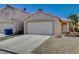 Two-story house with attached garage and a gravel driveway at 501 Riata Way, Las Vegas, NV 89110