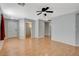 Living room featuring laminate flooring, a ceiling fan, and views to other rooms at 501 Riata Way, Las Vegas, NV 89110