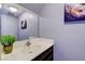 Updated bathroom with dark vanity and contemporary art at 5457 Escondido St, Las Vegas, NV 89119