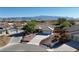 Single-story home with a two-car garage, landscaped yard, and mountain views at 5480 Lincolnwood Ct, Pahrump, NV 89061