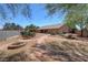 Landscaped backyard featuring a flagstone path, garden and pergola at 5480 Lincolnwood Ct, Pahrump, NV 89061