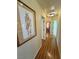 Long hallway with hardwood floors and artwork at 5480 Lincolnwood Ct, Pahrump, NV 89061