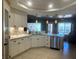 Modern kitchen with white cabinets, marble countertops and stainless steel appliances at 5480 Lincolnwood Ct, Pahrump, NV 89061