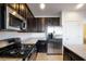 Modern kitchen with stainless steel appliances and dark wood cabinets at 628 Taliput Palm Pl, Henderson, NV 89011