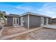 Gray house exterior with patio, backyard, and multiple entrances at 6290 Craigmont Ave, Las Vegas, NV 89103