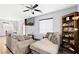 Living area featuring a sectional sofa and built-in bookcase at 649 Taliput Palm Pl, Henderson, NV 89011