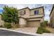 Two-story house with tan exterior, red shutters, and a paved driveway at 7788 Ebro Valley Ct, Las Vegas, NV 89113