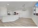 Modern kitchen with island, white cabinets, stainless steel appliances, and hardwood floors at 9316 Perennial Ave, Las Vegas, NV 89148