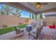 Covered patio with fire pit and seating area, perfect for outdoor entertaining at 9994 Chaparral Wind Ave, Las Vegas, NV 89166