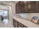 Kitchen boasts ample counter space and dark brown cabinets at 9994 Chaparral Wind Ave, Las Vegas, NV 89166